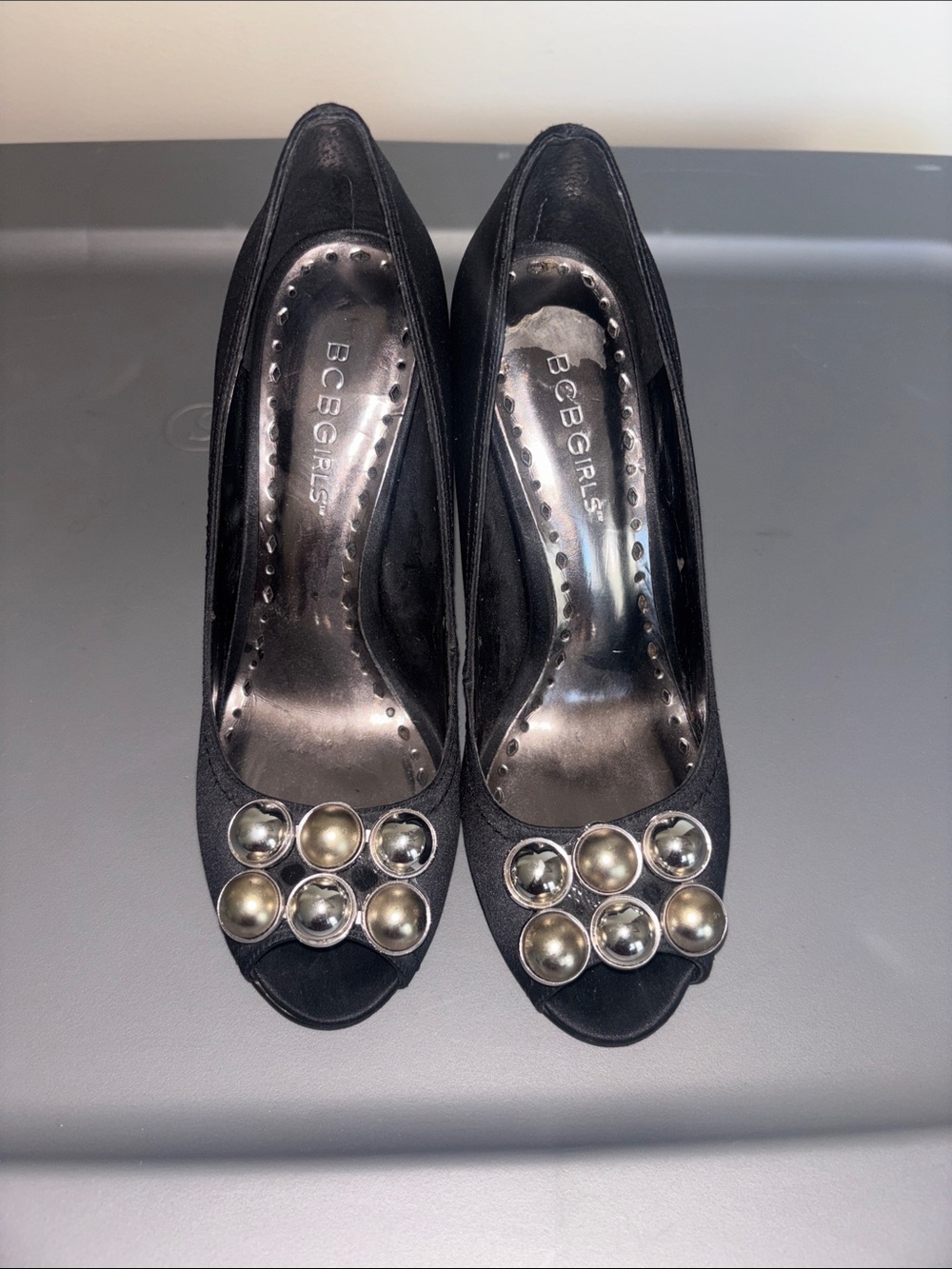 BCBGirls Black Peep-Toe Heels with Silver-Tone Orb Accents